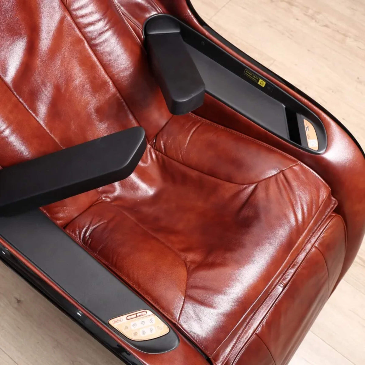 Close-up of the armrest and control panel on the DR.BOSS FJ-2025 in burgundy leather