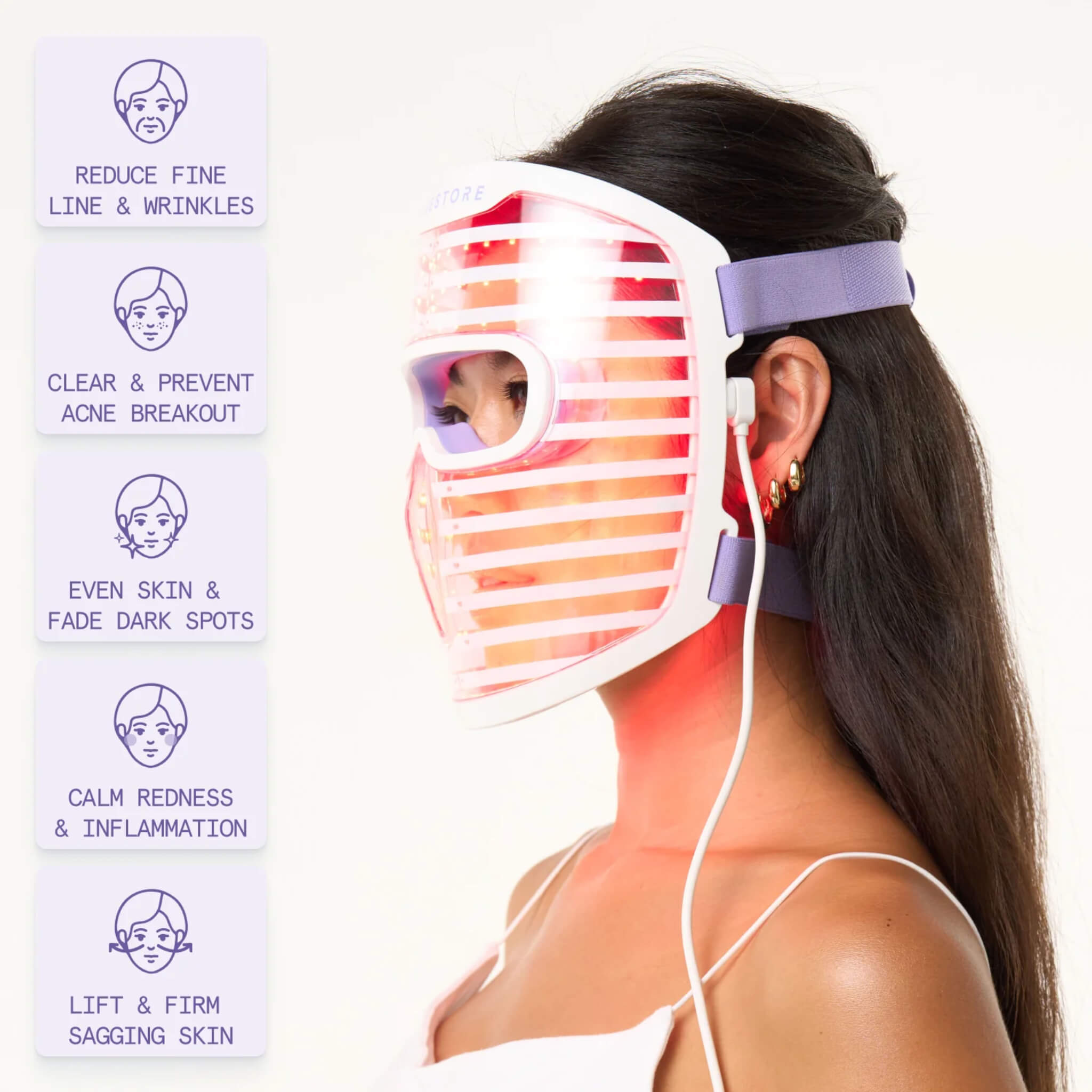Woman wearing the iRESTORE Illumina face mask with listed skin benefits including fine lines, redness, and dark spots