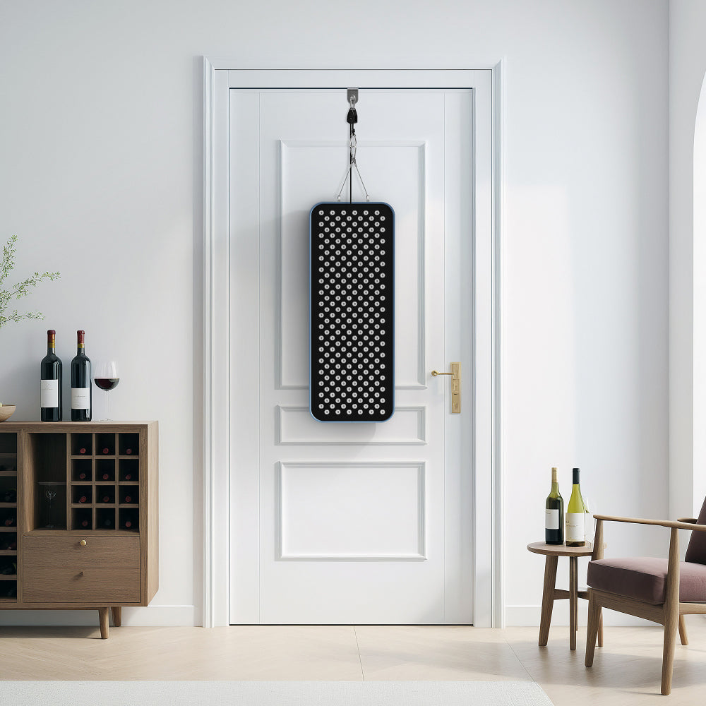 RLT Home Total Spectrum COMPACT Red Light Therapy Device hanging on a door with the included door hanging kit