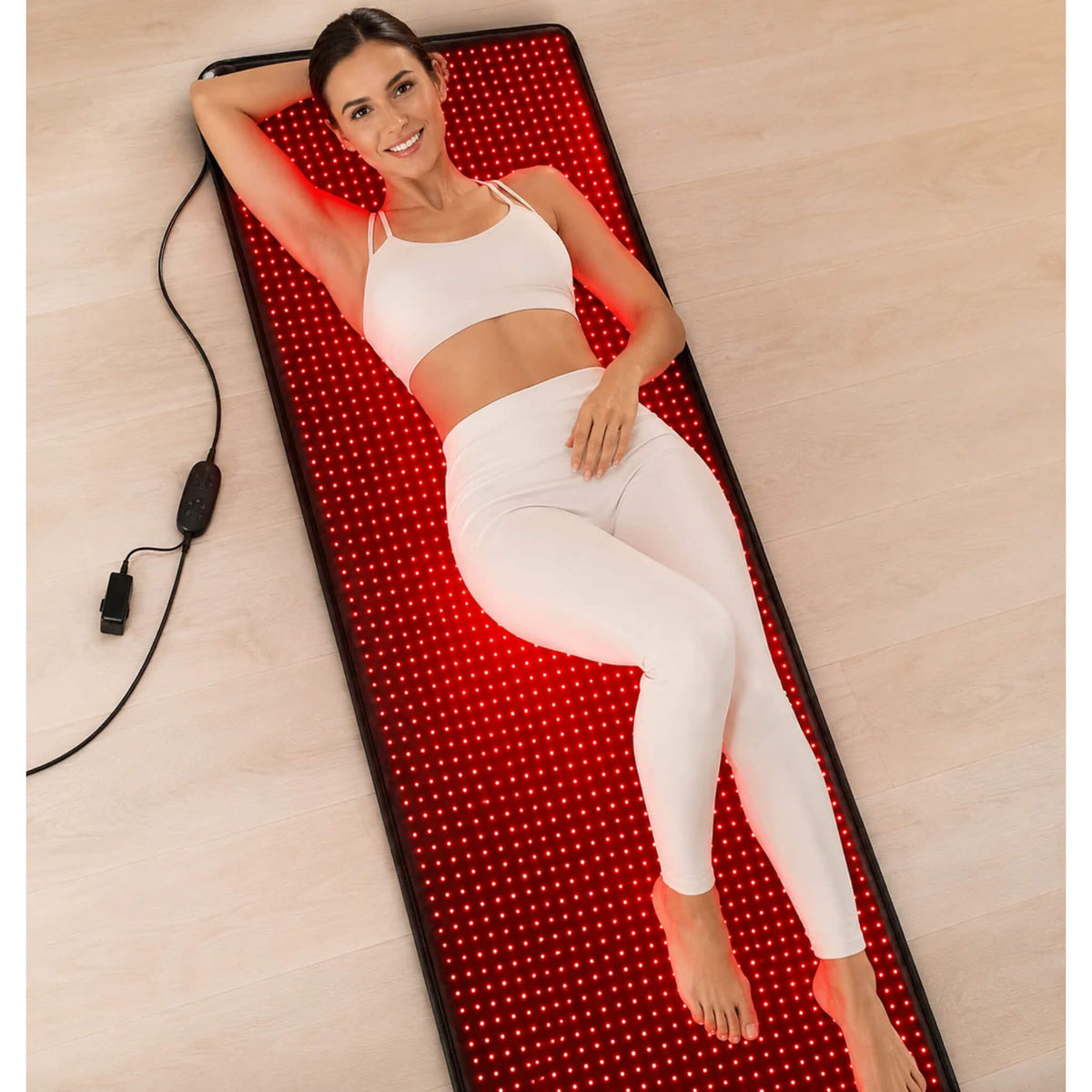 Woman lying on the Dr. Fuji LED Red Light Therapy Mat during a full body red light therapy session