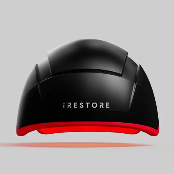 iRESTORE Elite laser hair growth helmet front view showing sleek black design with red light base