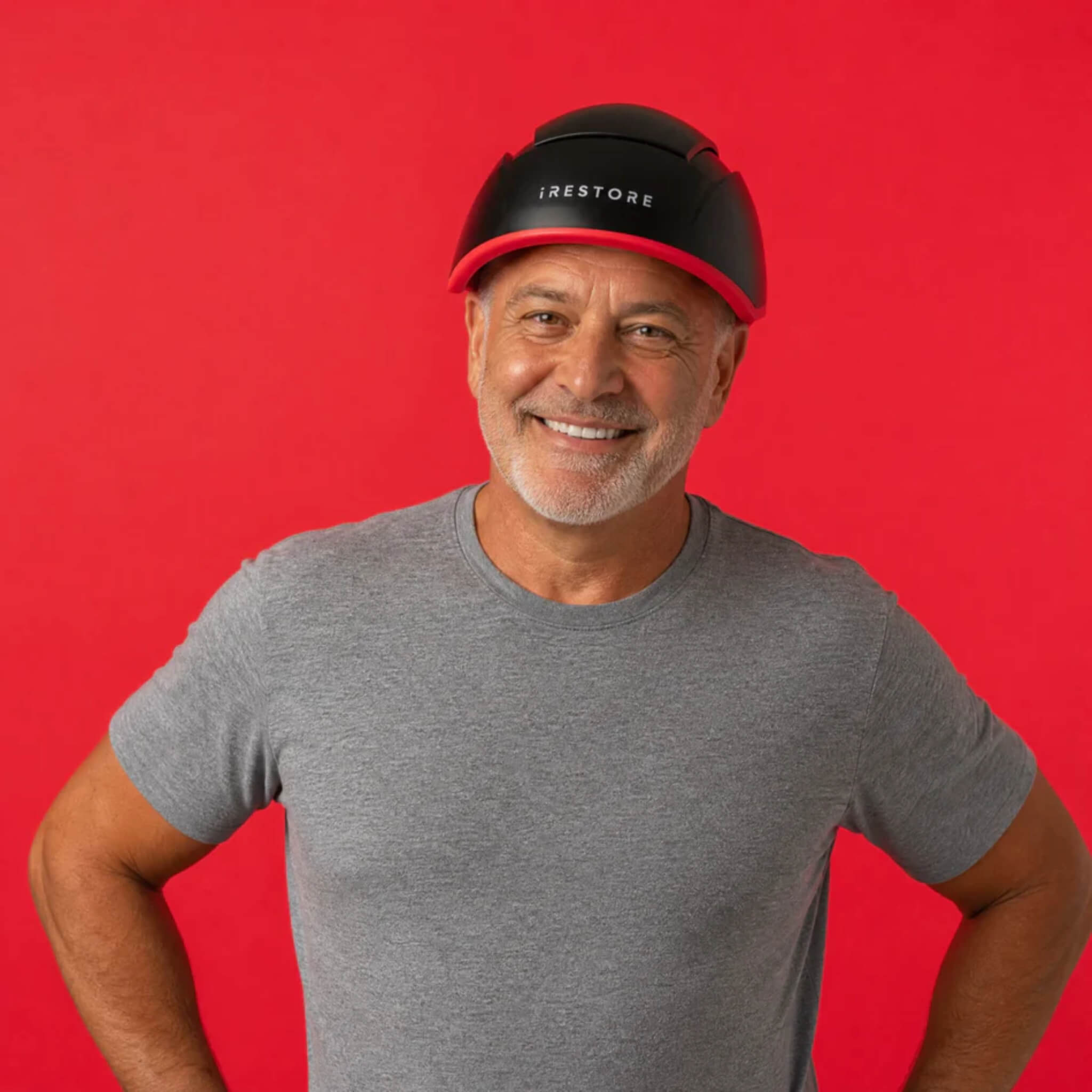 Mature man wearing iRESTORE Elite laser hair growth system showing suitability for hereditary hair thinning