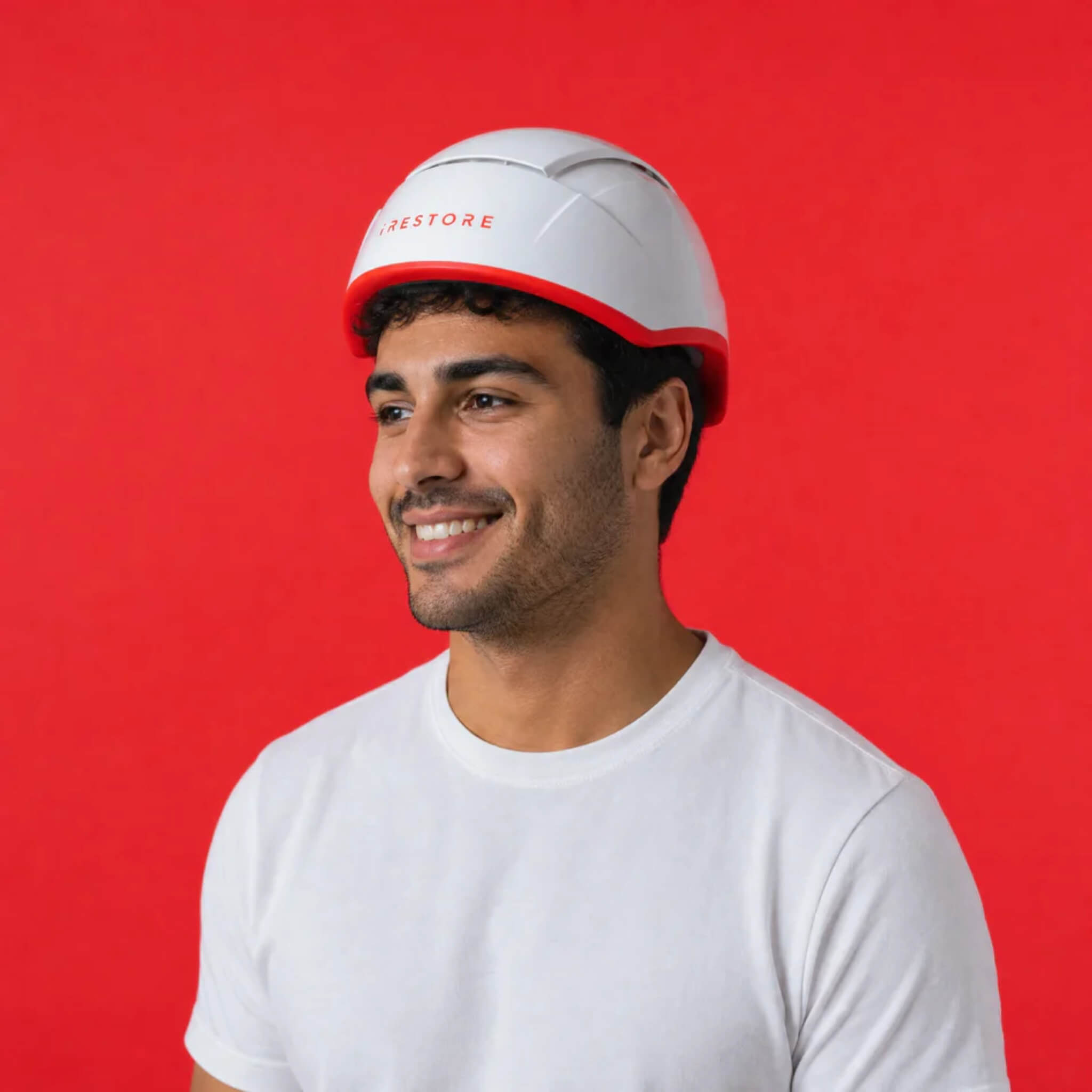 Man wearing iRESTORE Professional laser hair growth cap in white t-shirt