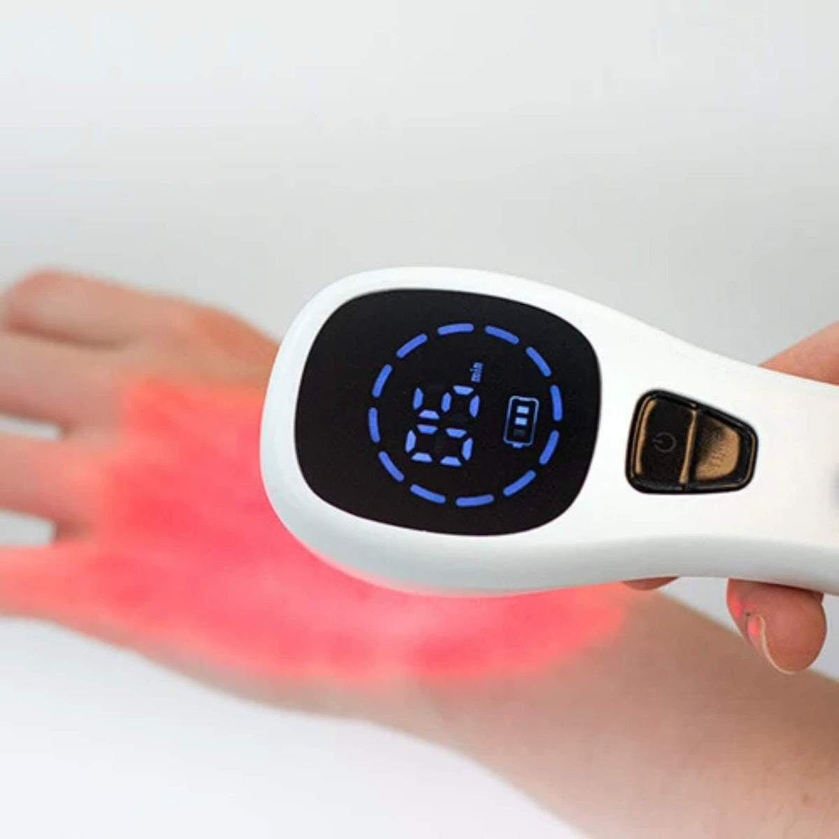Close up of the NovaaLab Novaa Extra Strength Laser LED timer screen with red light on the back of a hand