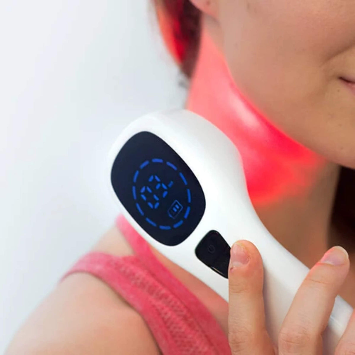 NovaaLab Novaa Extra Strength Laser held against the neck with red light visible