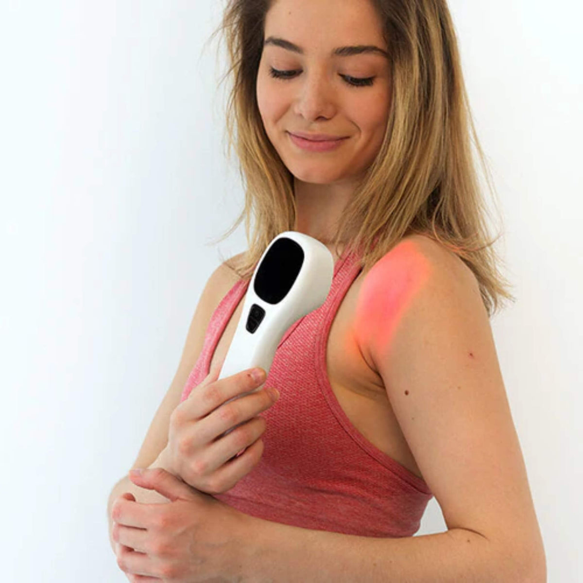 Woman holding the NovaaLab Novaa Extra Strength Laser over her shoulder