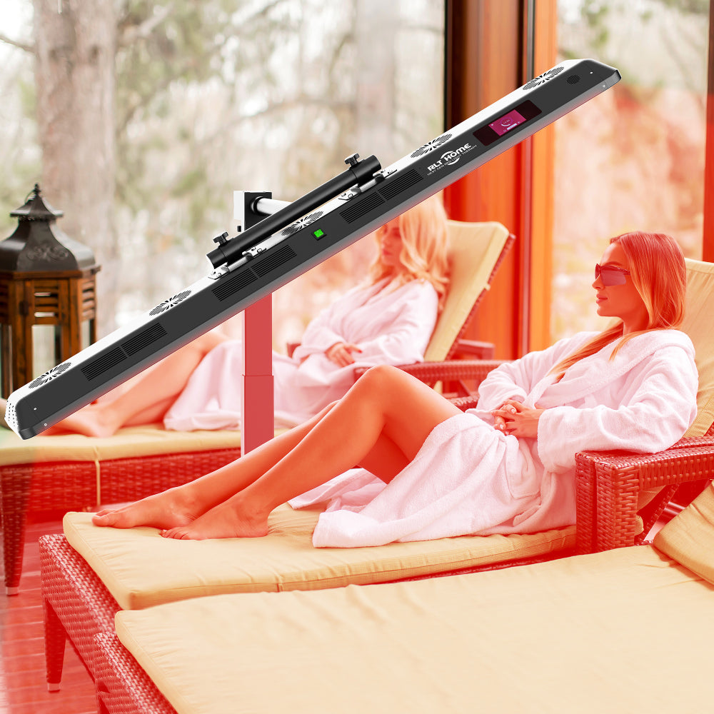 Woman lying on a bed at home under the RLT Home Total Spectrum ULTRA Red Light Therapy Device set horizontal