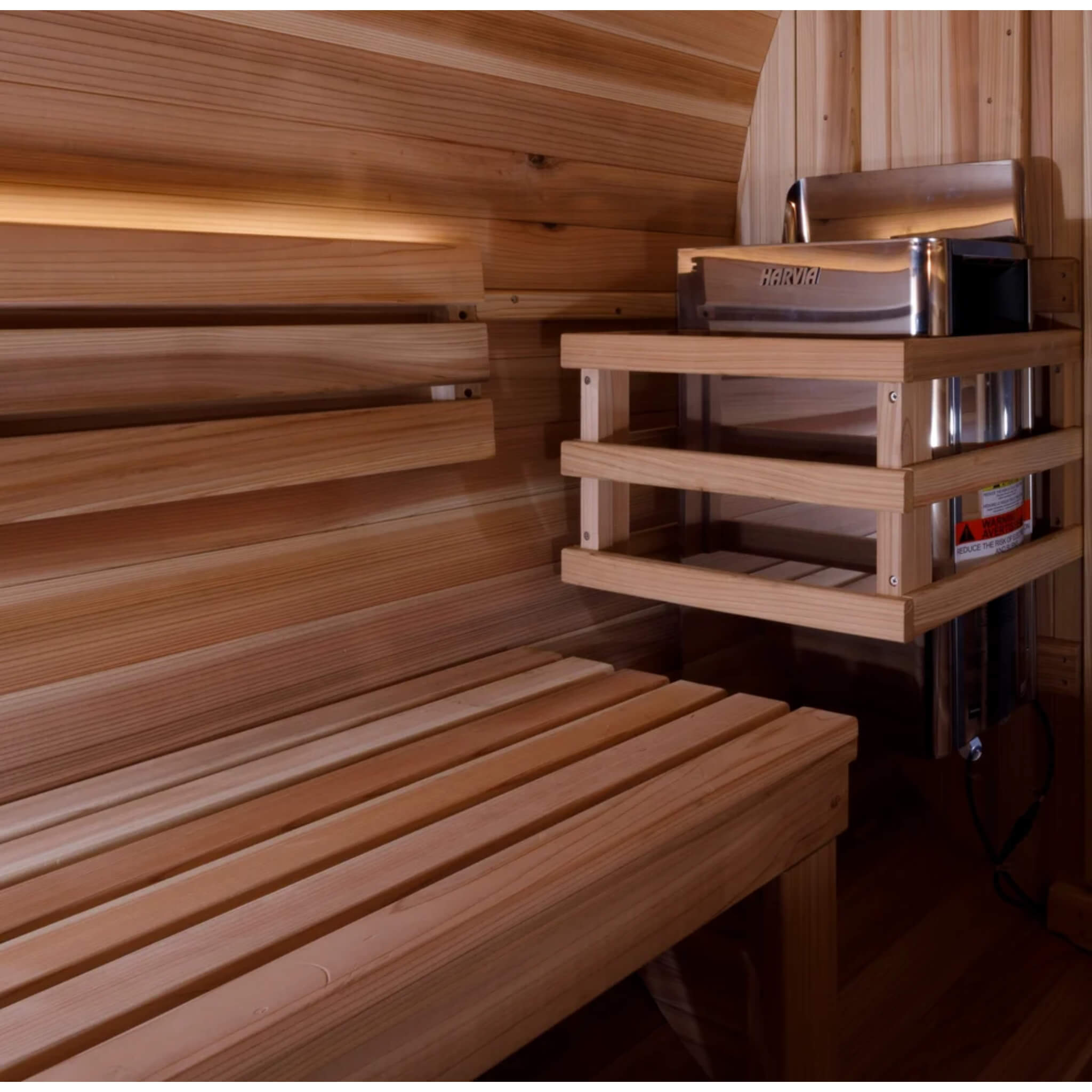Close up of the Zurich Barrel Sauna interior showing the bench, stove guard, and heater mount